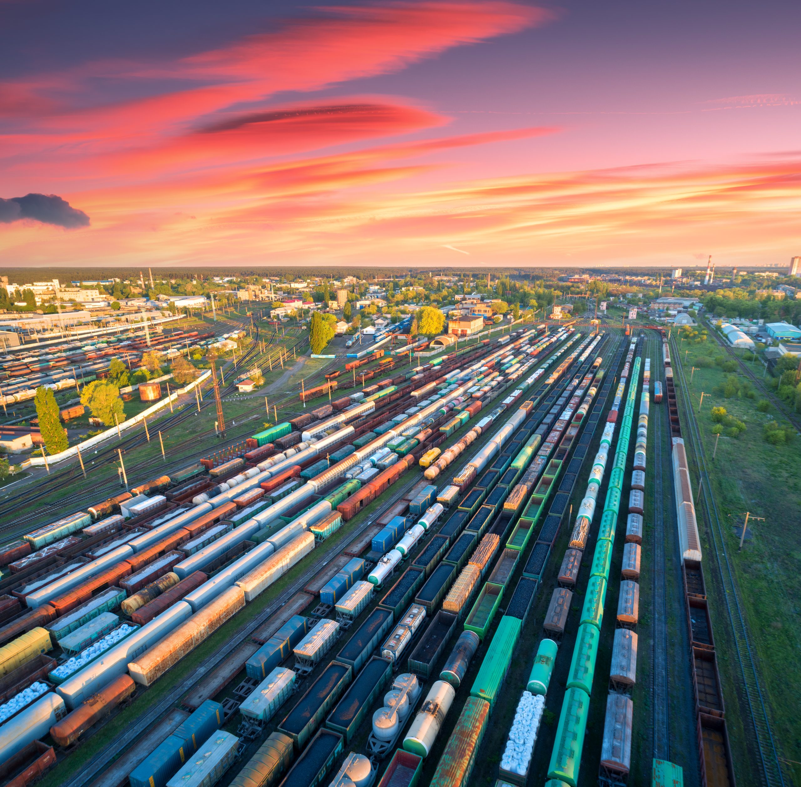 Aerial view of freight trains on railway station at sunset